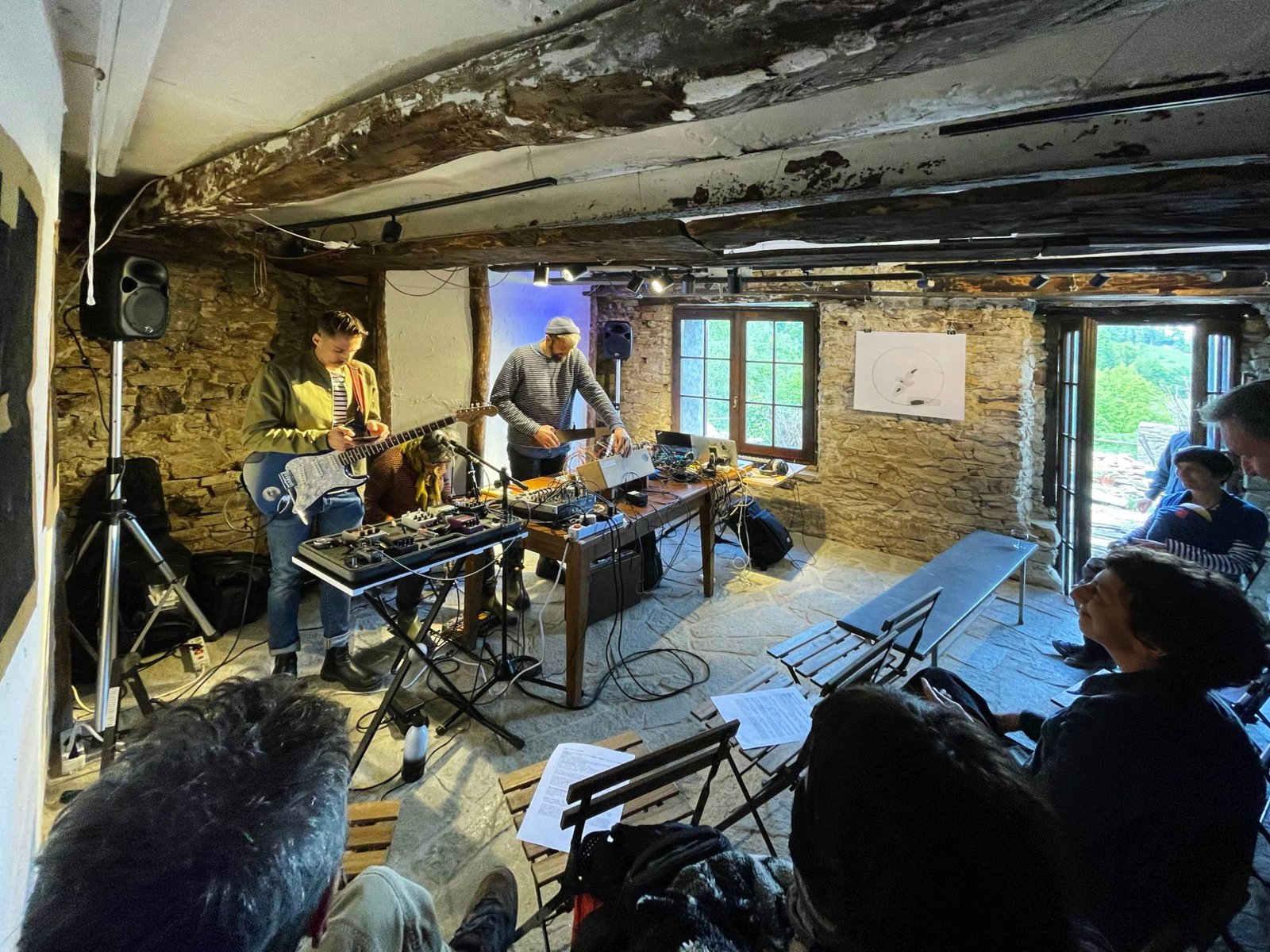 A sound and guitar performance in the stone-walled hall